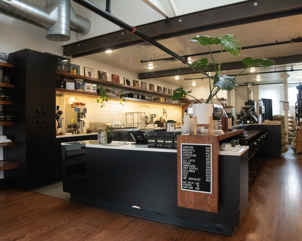 Modern specialty coffee shop in Eugene, Oregon market district. Avocado toast, pastries, bar seating, espresso, coffee roaster, indoor plants, retail coffee, and an open concept. Locally roasted coffee, offered in light and medium roasts profiles.